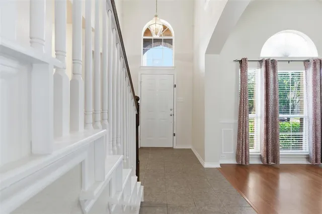 a view of a hallway with wooden floor and entryway