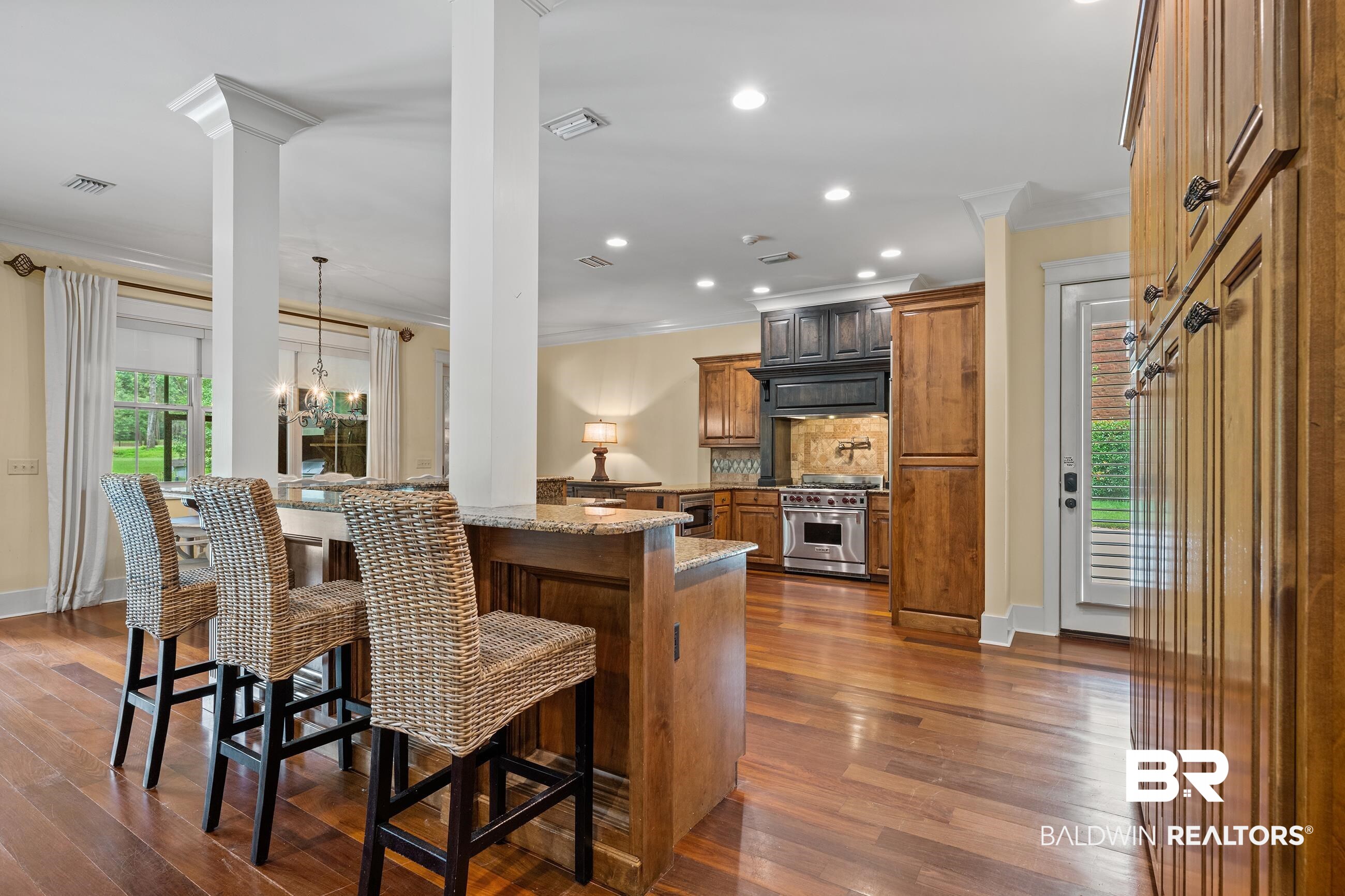30463 Dolive Ridge Daphne, AL 36527 - Photo 41 of 58 Gourmet kitchen featuring hardwood flooring, granite countertops, recessed lighting, stainless steel range, and custom cabinetry