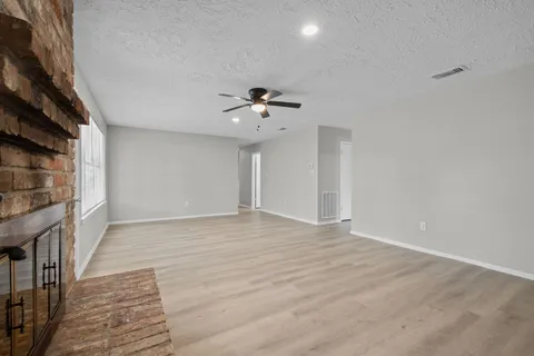 a view of an empty room with a ceiling fan