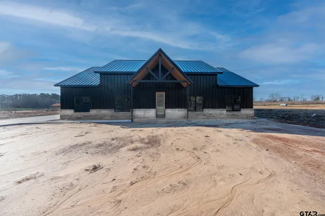 a wooden bench sitting in front of a house