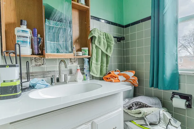 a bathroom with a sink mirror and toilet