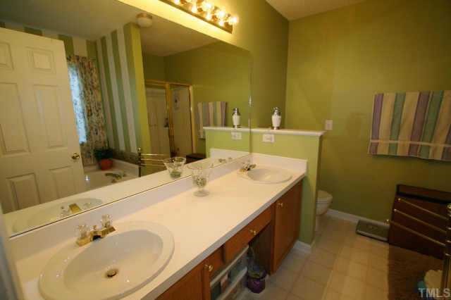 4409 Drewbridge Way Raleigh, NC 27604 - Photo 7 of 11 a bathroom with a double vanity sink and a mirror