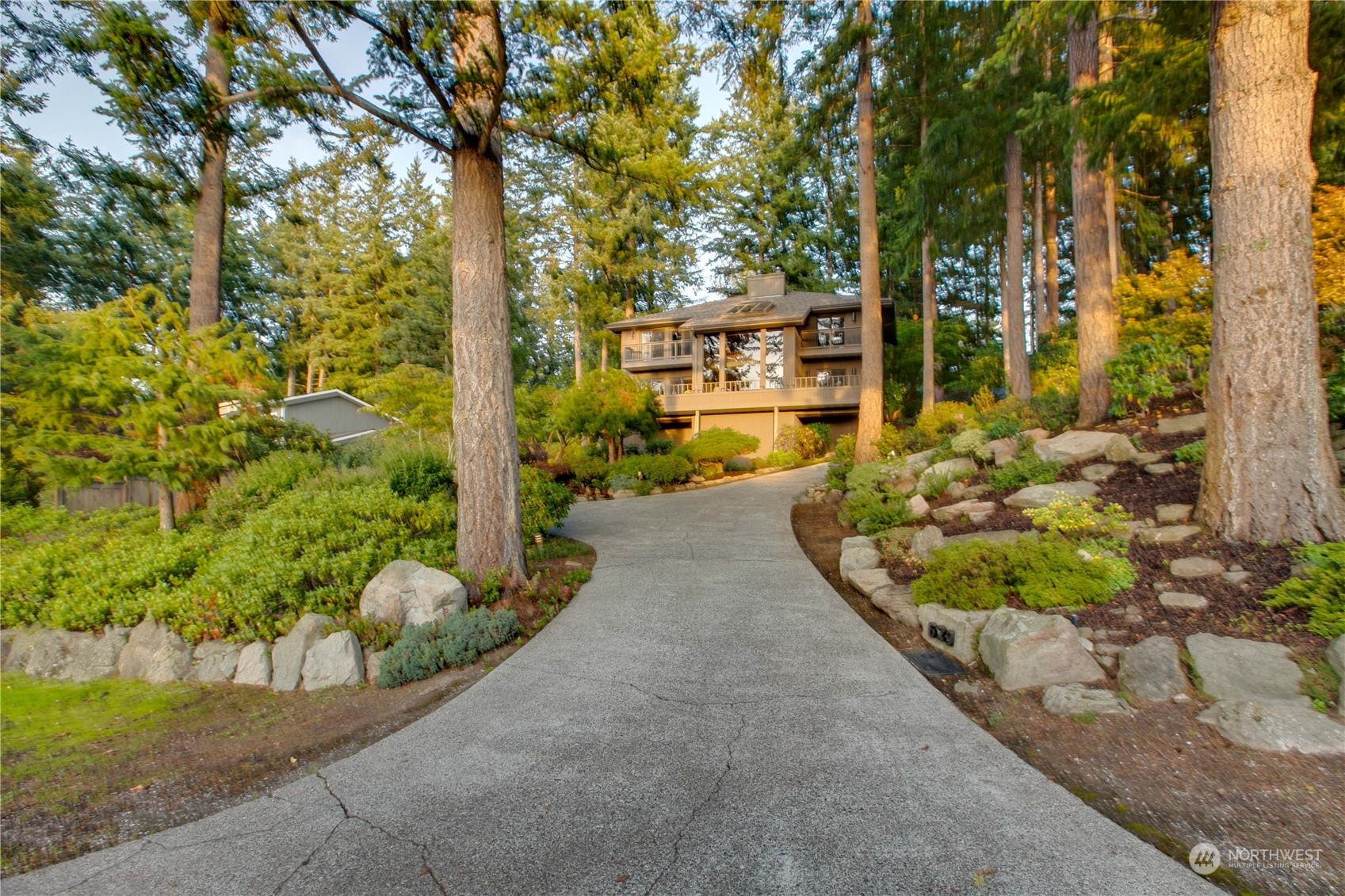629 Fieldston Road Bellingham, WA 98225 - Photo 3 of 40 a view of a street with potted plants and large trees