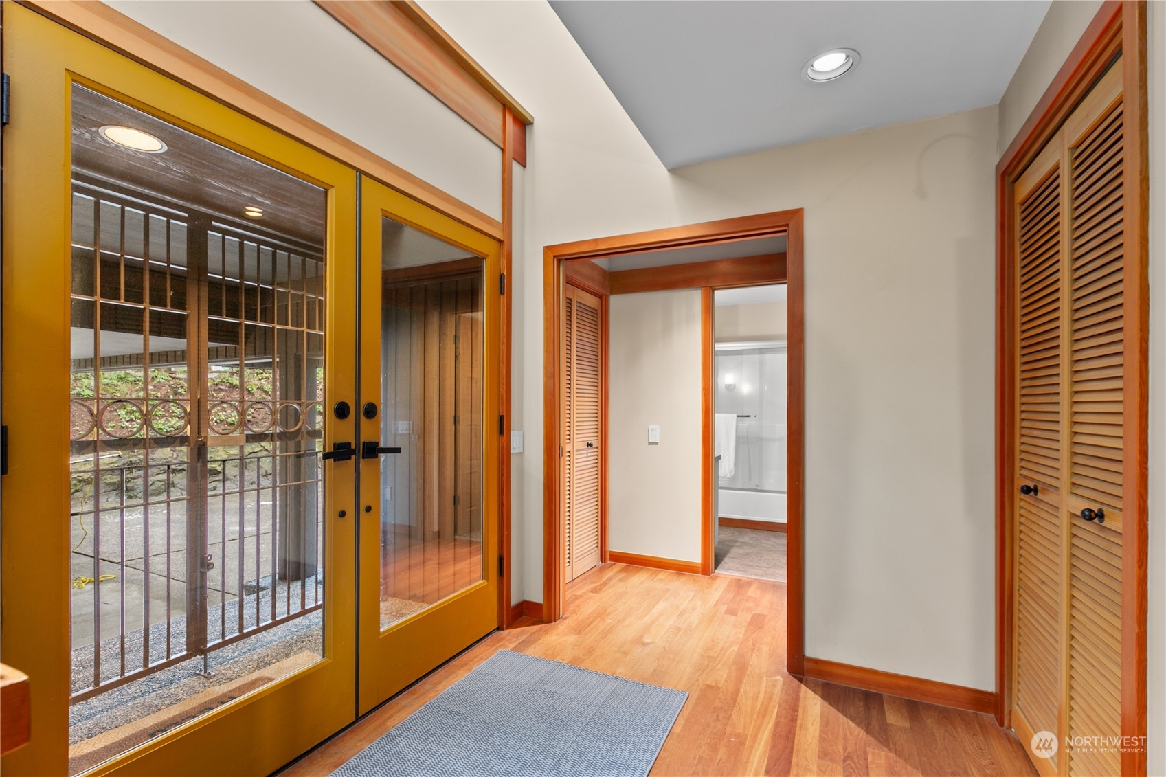 629 Fieldston Road Bellingham, WA 98225 - Photo 5 of 40 a view of a hallway with wooden floor and glass door