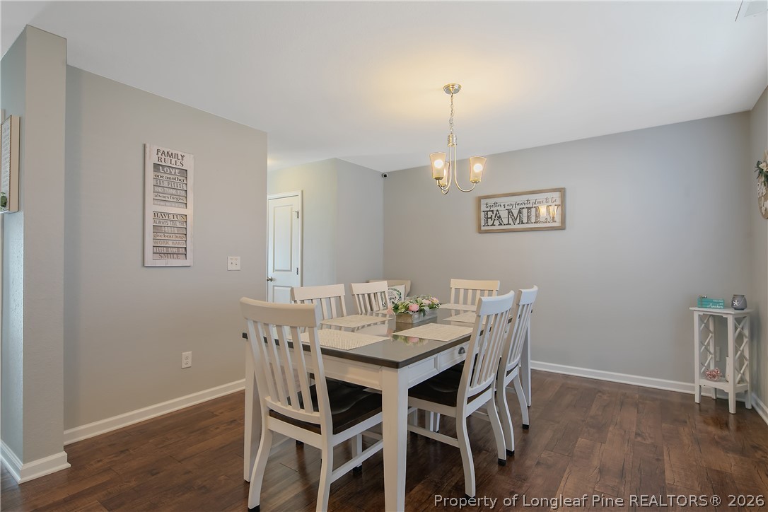 340 Battery Way Bunnlevel, NC 28323 - Photo 5 of 50 a view of a dining room with furniture and wooden floor