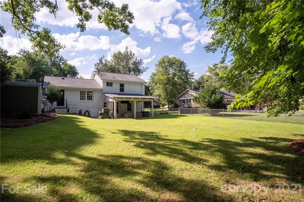 5619 Londonderry Road Charlotte, NC 28210 - Photo 21 of 23 a view of a house with a big yard and large trees