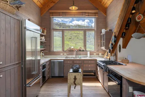 a kitchen with lots of counter top space and appliances