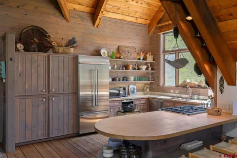a kitchen with a table and chairs