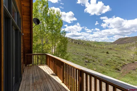 a view of a balcony with wooden floor