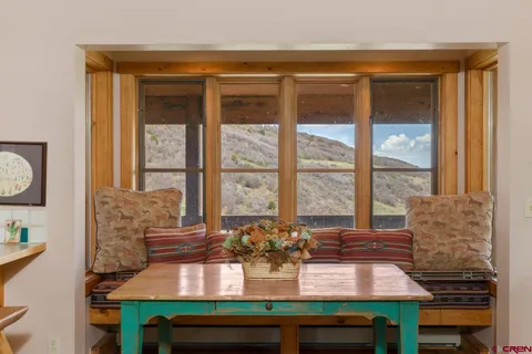 a view of a dining room with furniture window and outside view