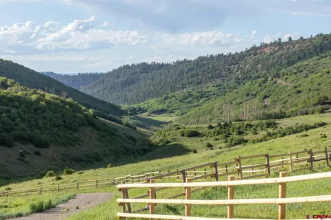 a view of a field with mountains in the background