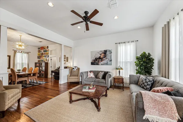 a living room with furniture and wooden floor