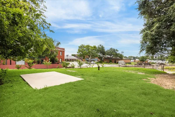 a view of yard with swimming pool and green space