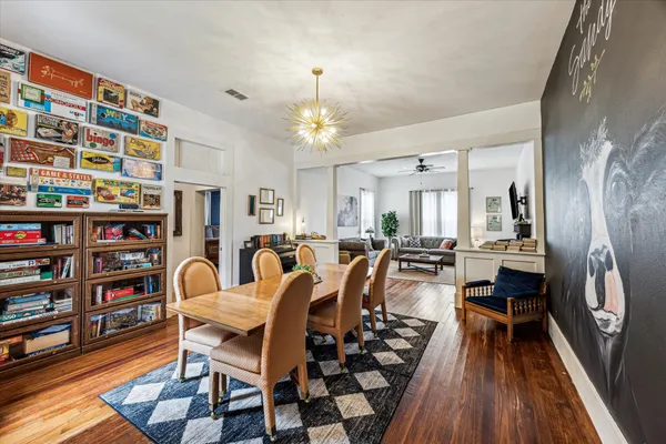 a very nice looking living room with furniture and a chandelier