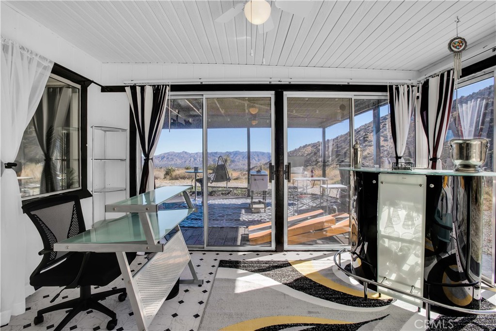 49490 Big Morongo Canyon Road Morongo Valley, CA 92256 - Photo 28 of 75 a view of a livingroom with furniture and a floor to ceiling window