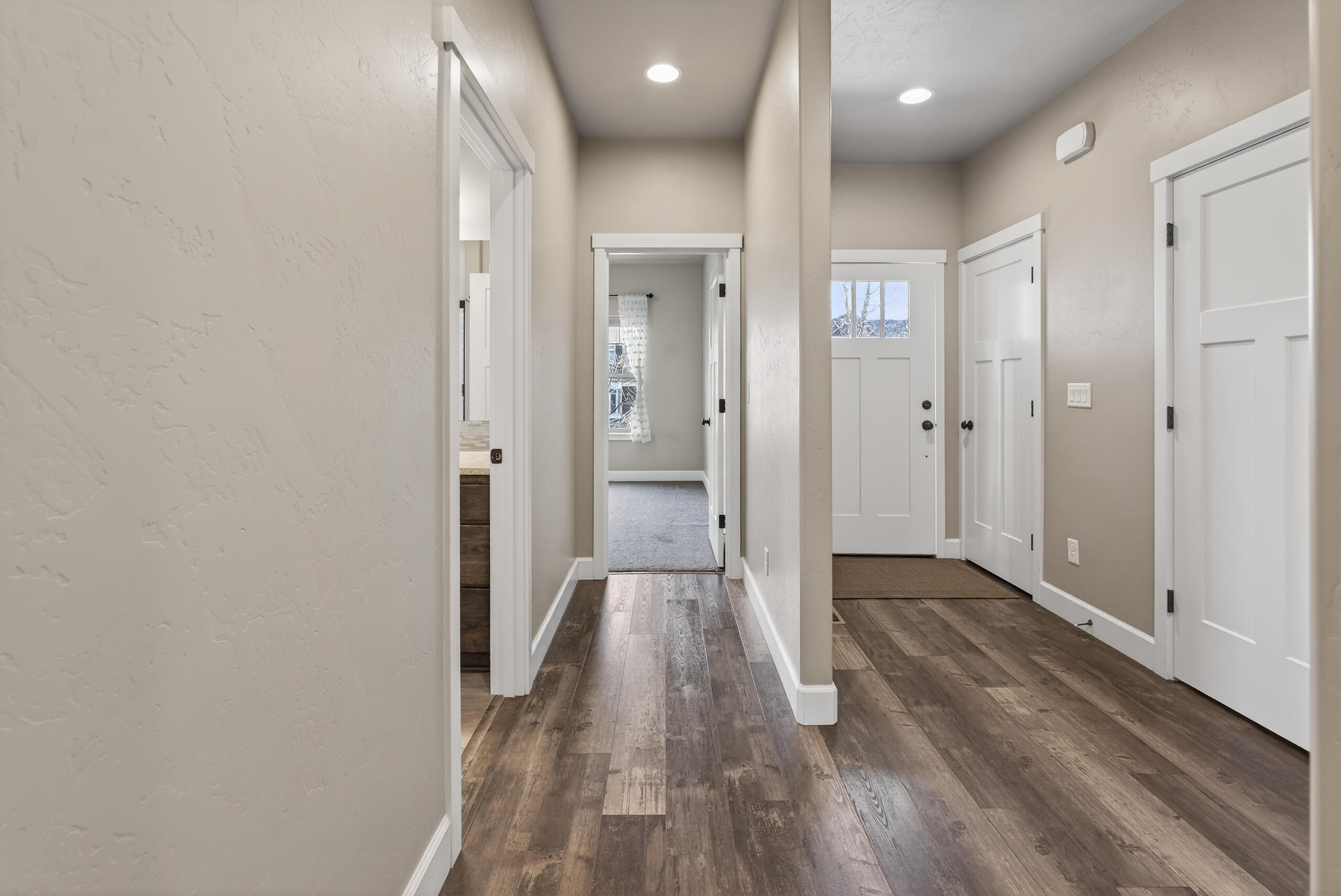 2793 Southwest 33rd Street Redmond, OR 97756 - Photo 22 of 44 a view of a hallway with wooden floor and a bathroom