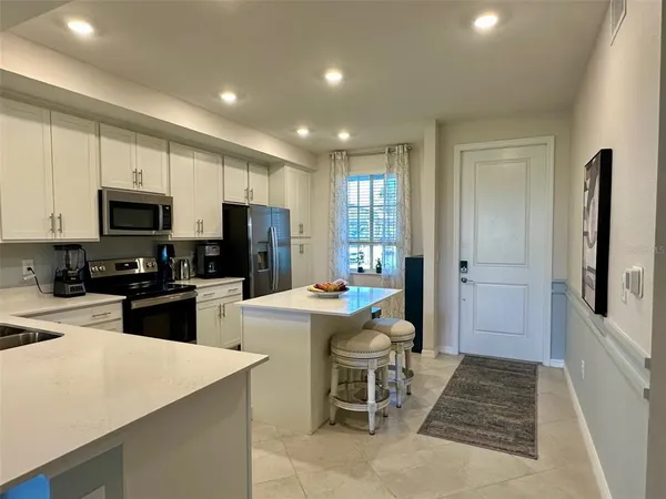 a kitchen with sink cabinets and refrigerator
