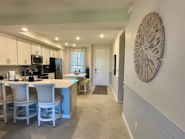a large kitchen with a table and chairs