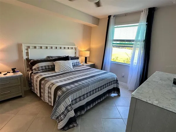 a bedroom with a bed and window