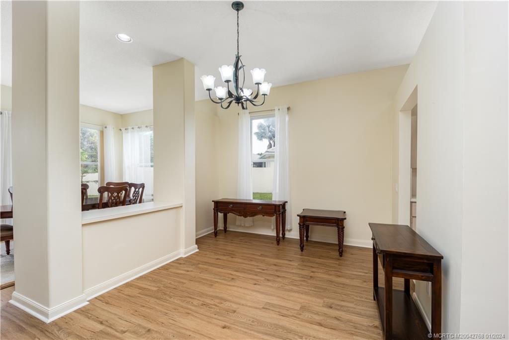 7199 Southeast Bitterroot Circle Hobe Sound, FL 33455 - Photo 14 of 28 a view of a livingroom with a chandelier furniture and wooden floor