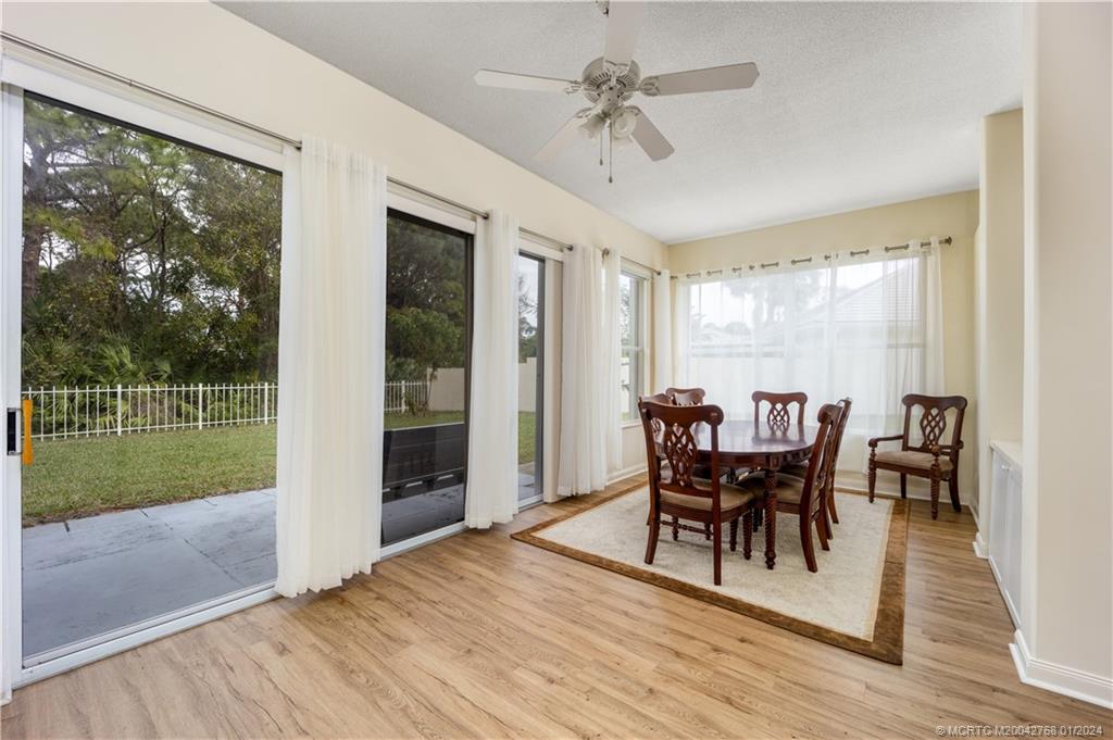 7199 Southeast Bitterroot Circle Hobe Sound, FL 33455 - Photo 15 of 28 a view of a dining room with furniture window and wooden floor