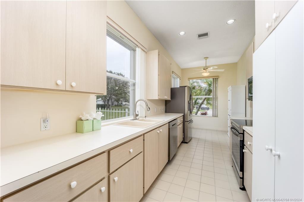 7199 Southeast Bitterroot Circle Hobe Sound, FL 33455 - Photo 17 of 28 a kitchen with a sink and cabinets