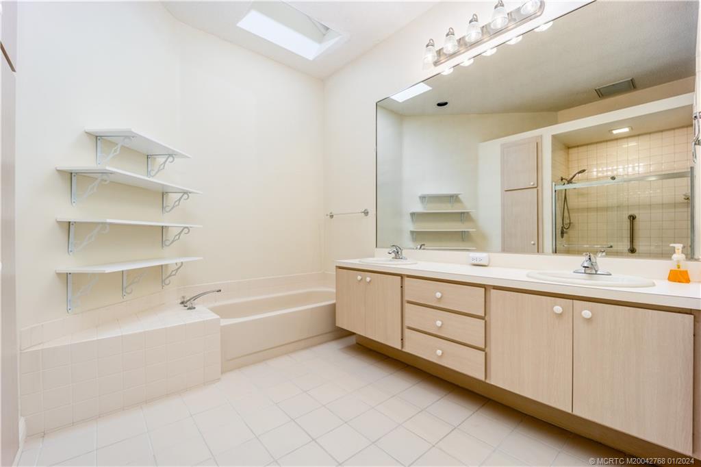7199 Southeast Bitterroot Circle Hobe Sound, FL 33455 - Photo 19 of 28 a spacious bathroom with a double vanity sink mirror and double