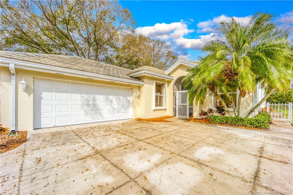 7199 Southeast Bitterroot Circle Hobe Sound, FL 33455 - Photo 2 of 28 a view of a house with a patio