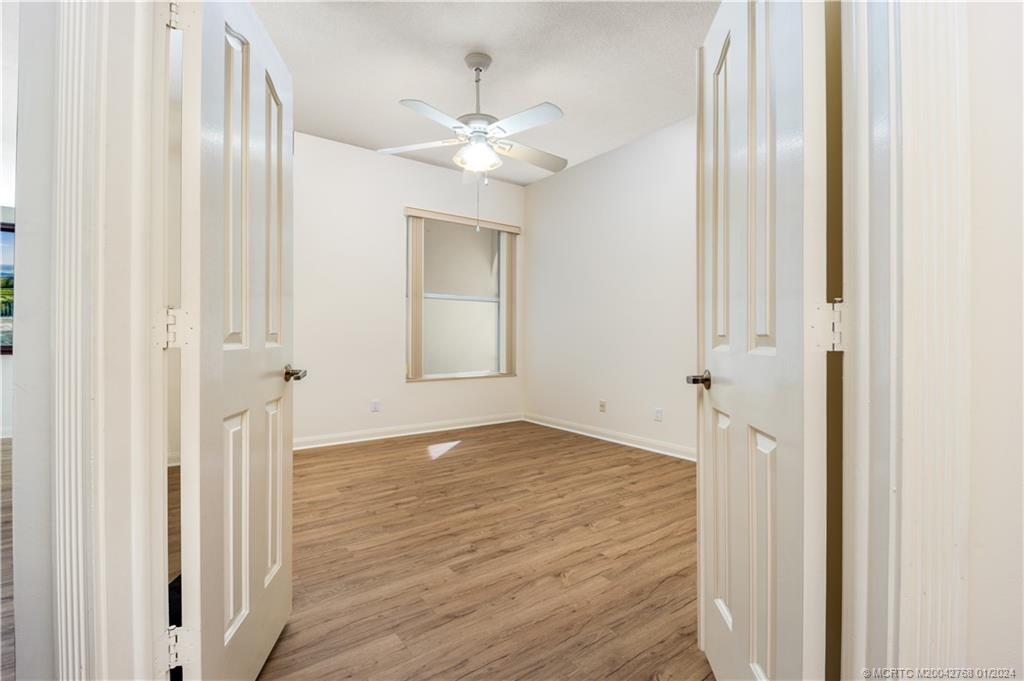 7199 Southeast Bitterroot Circle Hobe Sound, FL 33455 - Photo 23 of 28 a view of an empty room with wooden floor and a window