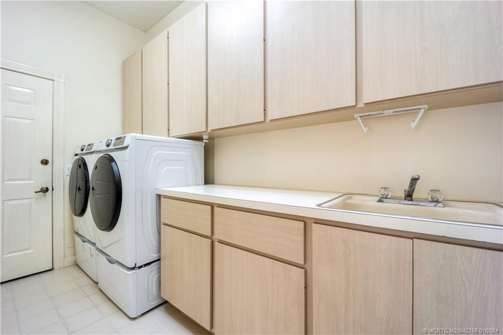 7199 Southeast Bitterroot Circle Hobe Sound, FL 33455 - Photo 27 of 28 a utility room with dryer and washer
