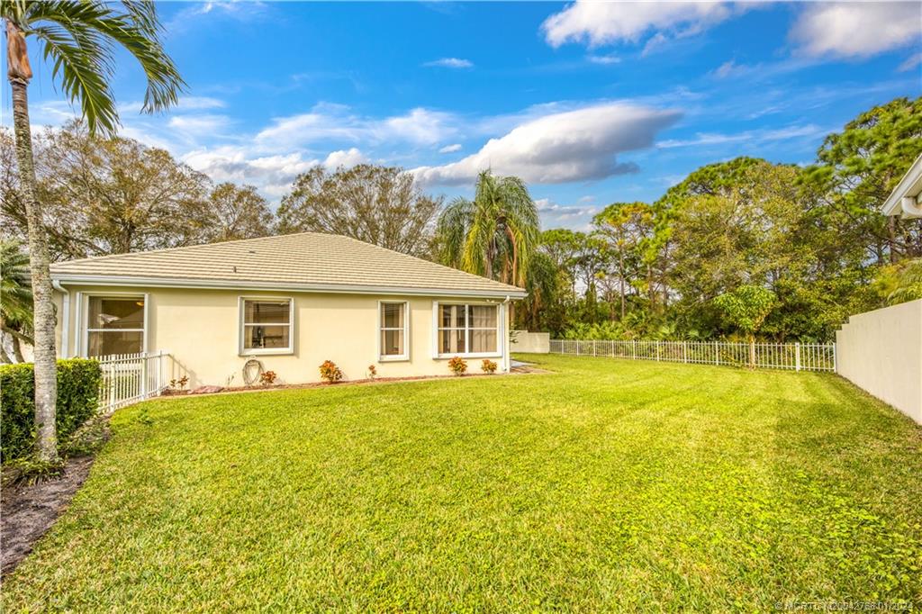 7199 Southeast Bitterroot Circle Hobe Sound, FL 33455 - Photo 28 of 28 a front view of house with yard and swimming pool