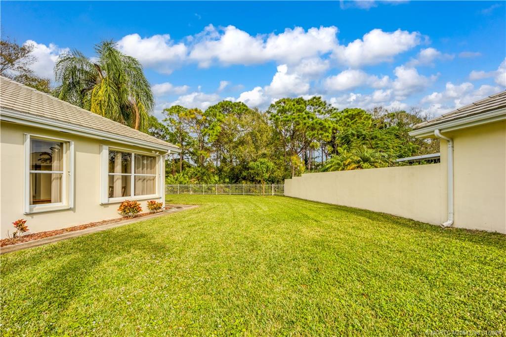7199 Southeast Bitterroot Circle Hobe Sound, FL 33455 - Photo 8 of 28 a view of a house with a backyard