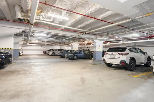 a view of parking garage with cars parked