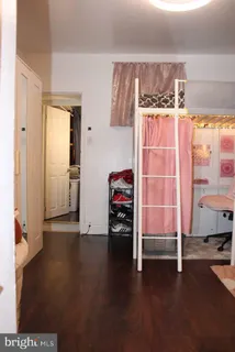 a view of a room with wooden floor and windows