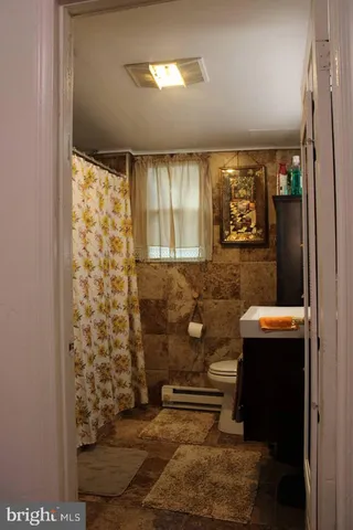 a bathroom with a toilet and a shower