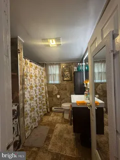 a room with patio outer view and a glass door shower