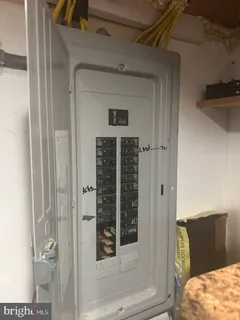 a view of a bedroom with a bed and wooden floor