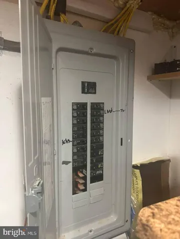 a view of a bedroom with a bed and wooden floor