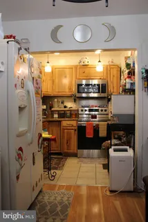 a kitchen with stainless steel appliances granite countertop a stove and a refrigerator