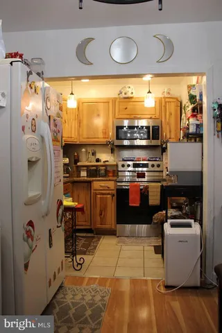 a kitchen with stainless steel appliances granite countertop a stove and a refrigerator