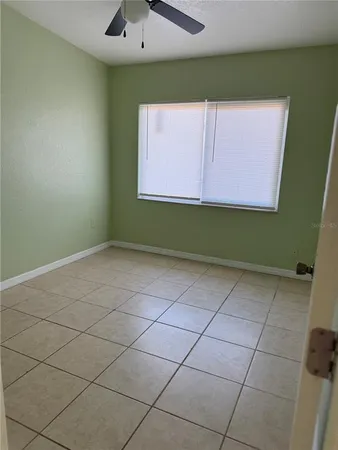 an empty room with a fireplace and cabinet