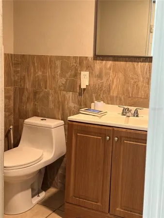 a bathroom with a sink a toilet and mirror