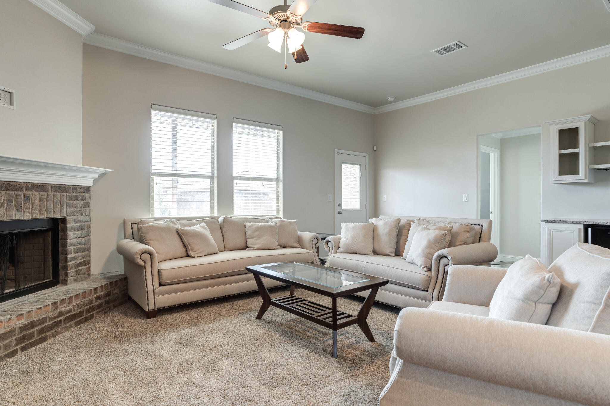 7535 103rd Street Lubbock, TX 79424 - Photo 15 of 35 a living room with furniture and a fireplace