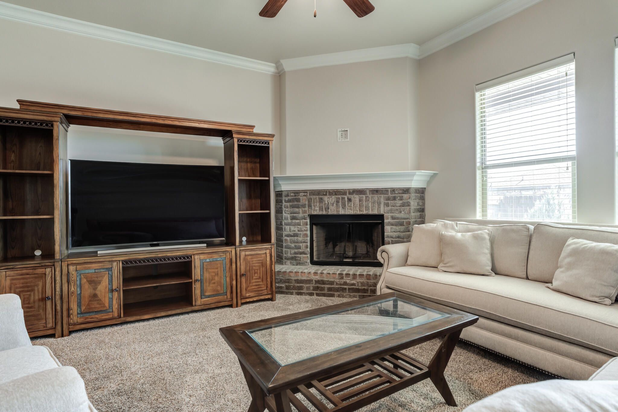 7535 103rd Street Lubbock, TX 79424 - Photo 16 of 35 a living room with furniture and a flat screen tv