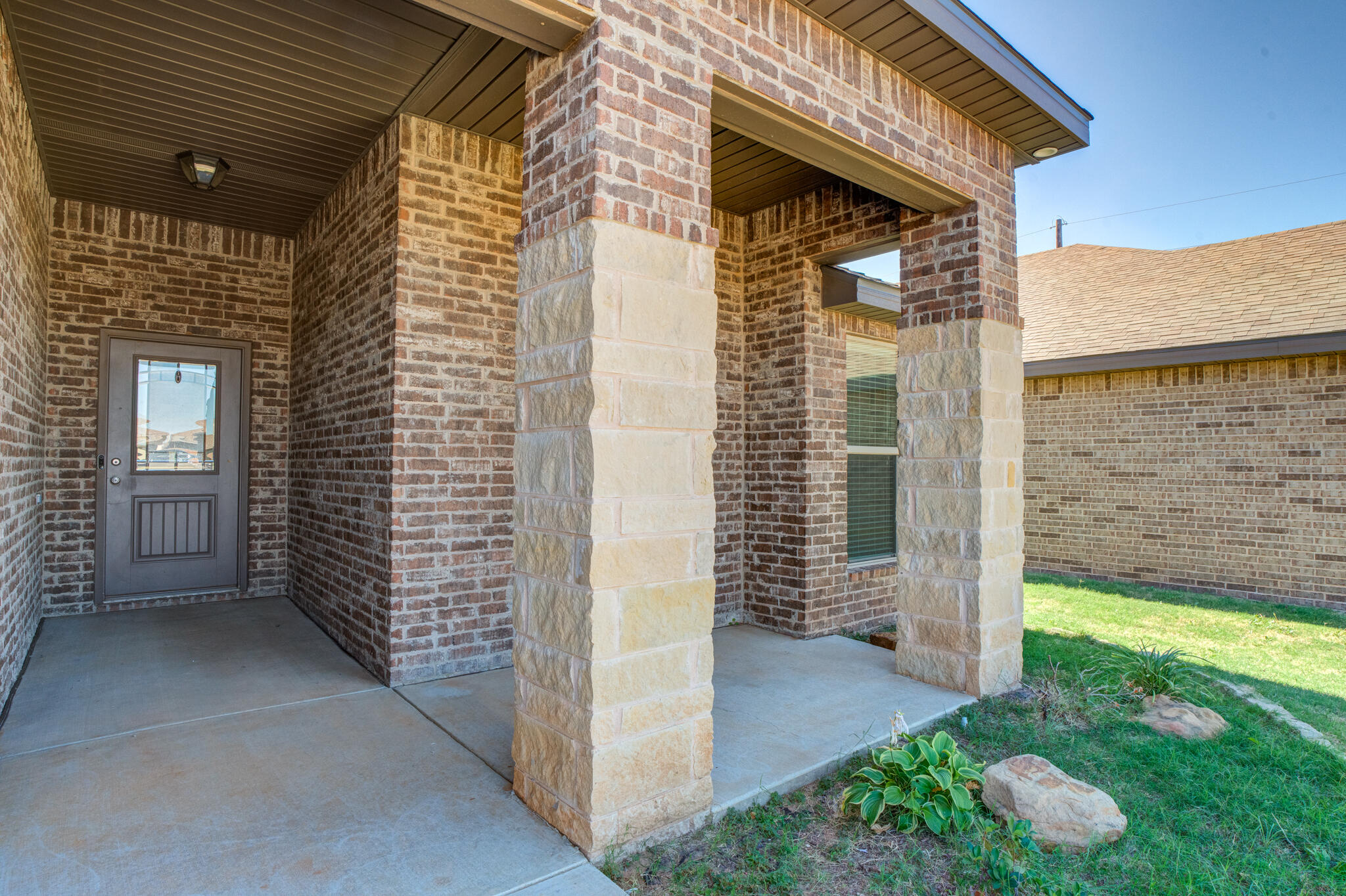 7535 103rd Street Lubbock, TX 79424 - Photo 3 of 35 a view of a porch with a door and a yard