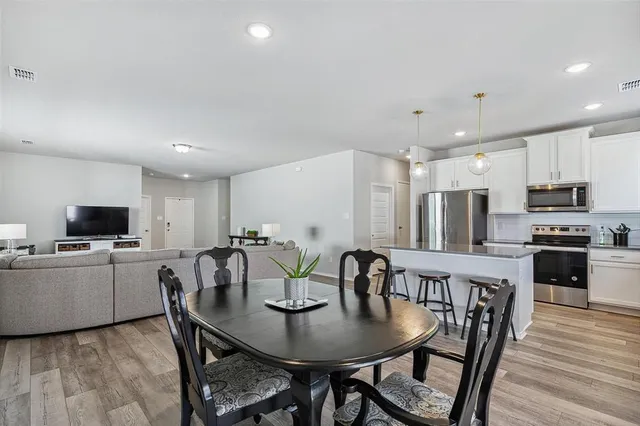 a view of a dining room with furniture and wooden floor
