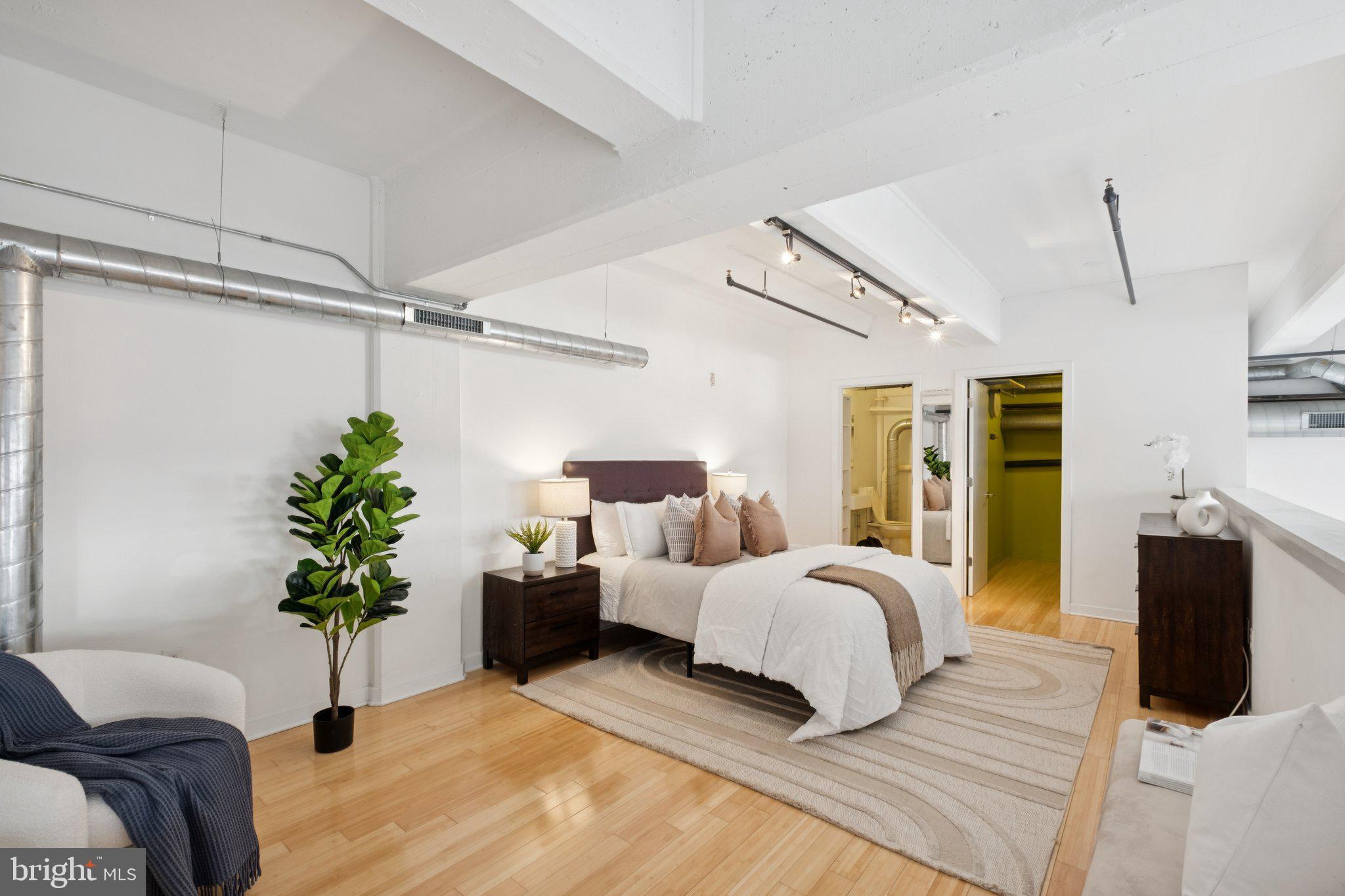 1234 Hamilton Street, Unit 102 Philadelphia, PA 19123 - Photo 15 of 25 a bedroom with a bed and a potted plant