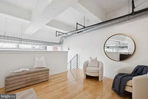 a bedroom with furniture and a mirror