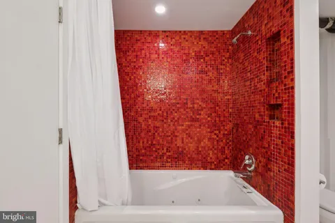 a bathroom with a bathtub and shower