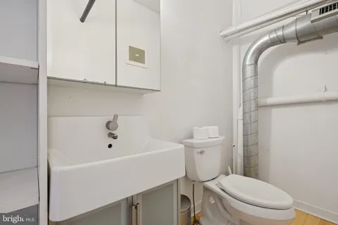 a white toilet sitting next to a bathroom sink